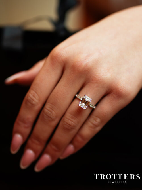 Trotters Platinum 3ct Lab Grown Emerald Cut Diamond Ring With Diamond Set Shoulders & Hidden Halo