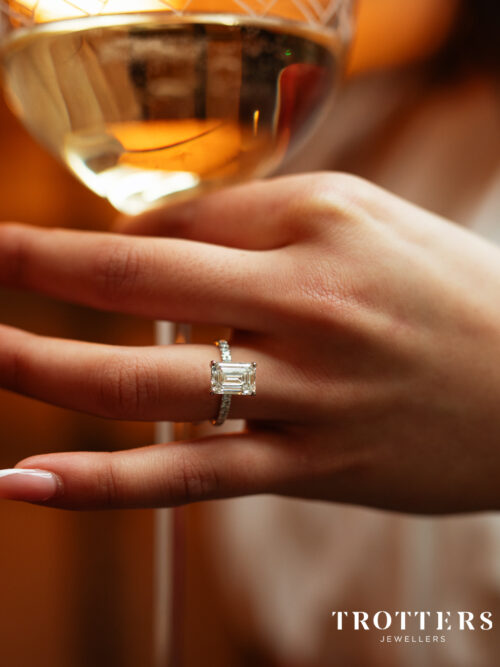 Trotters Platinum 3ct Lab Grown Emerald Cut Diamond Ring With Diamond Set Shoulders & Hidden Halo