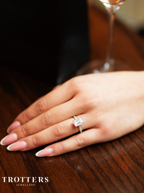 Trotters Platinum 3ct Lab Grown Emerald Cut Diamond Ring With Diamond Set Shoulders & Hidden Halo