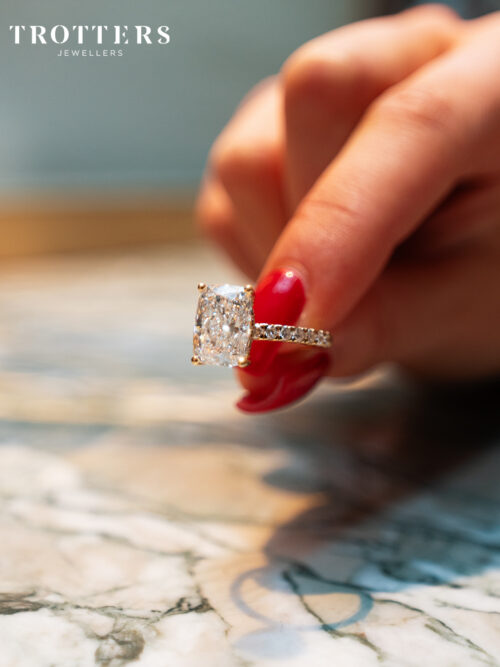 Trotters 18ct Yellow Gold 3ct Cushion Cut Lab Grown Diamond Ring With Diamond Set Shoulders And Hidden Diamond Halo