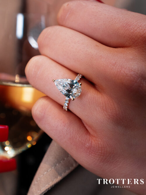 Trotters 18ct Yellow Gold 3ct Pear Cut Lab Grown Diamond Ring With Diamond Set Shoulders And Diamond Set Claws