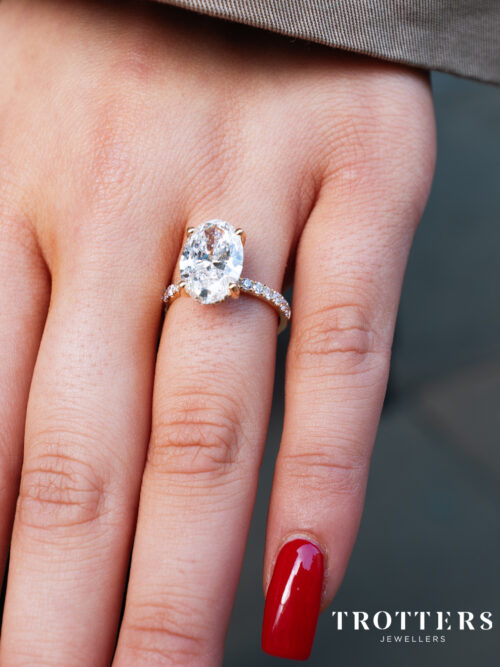 Trotters 18ct Yellow Gold 4ct Lab Grown Oval Diamond Ring With Diamond Set Shoulders & Hidden Diamond Halo