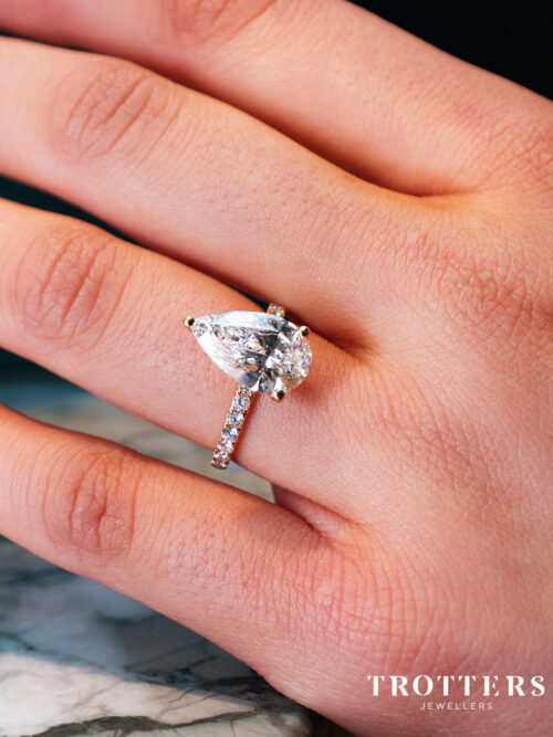 Trotters 18ct Yellow Gold 3ct Pear Cut Lab Grown Diamond Ring With Diamond Set Shoulders And Diamond Set Claws