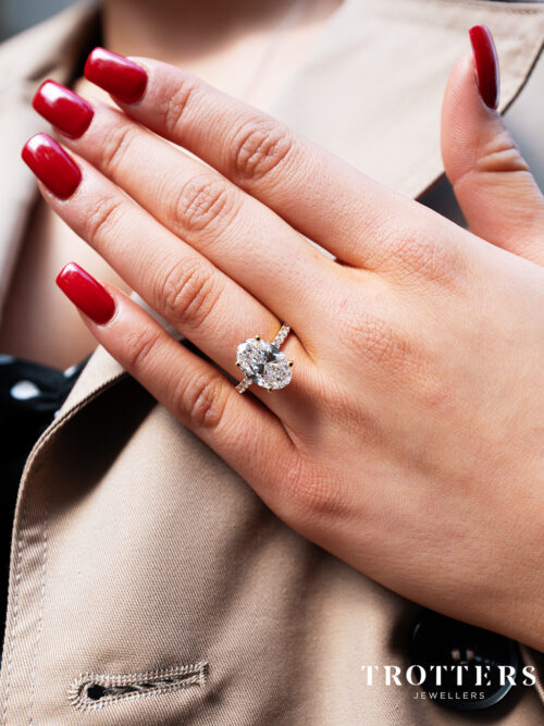 Trotters 18ct Yellow Gold 4ct Lab Grown Oval Diamond Ring With Diamond Set Shoulders & Hidden Diamond Halo