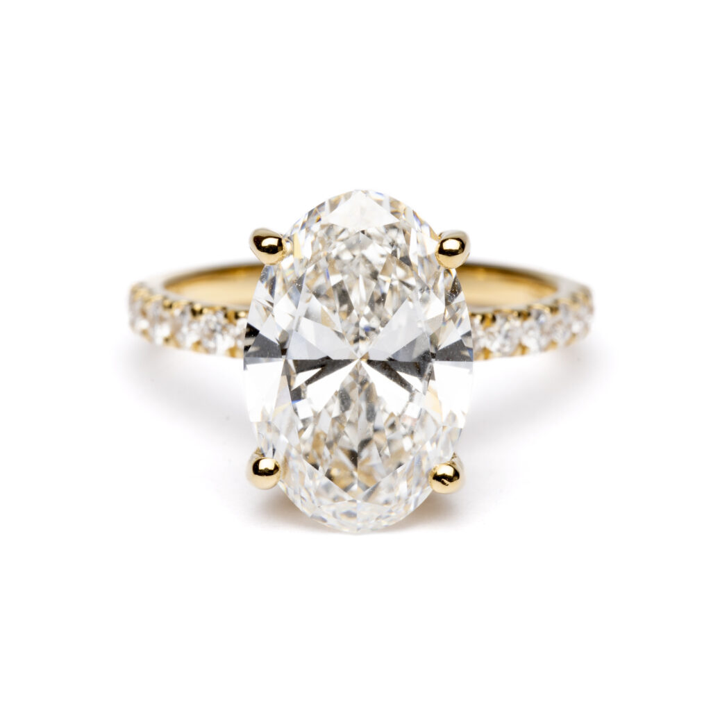 Trotters 18ct Yellow Gold 4ct Lab Grown Oval Diamond Ring With Diamond Set Shoulders & Hidden Diamond Halo