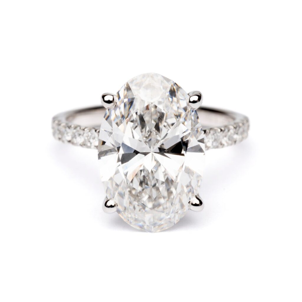 Trotters Platinum 5ct Oval Cut Lab Grown Diamond Ring With Diamond Set Shoulders And Hidden Diamond Halo